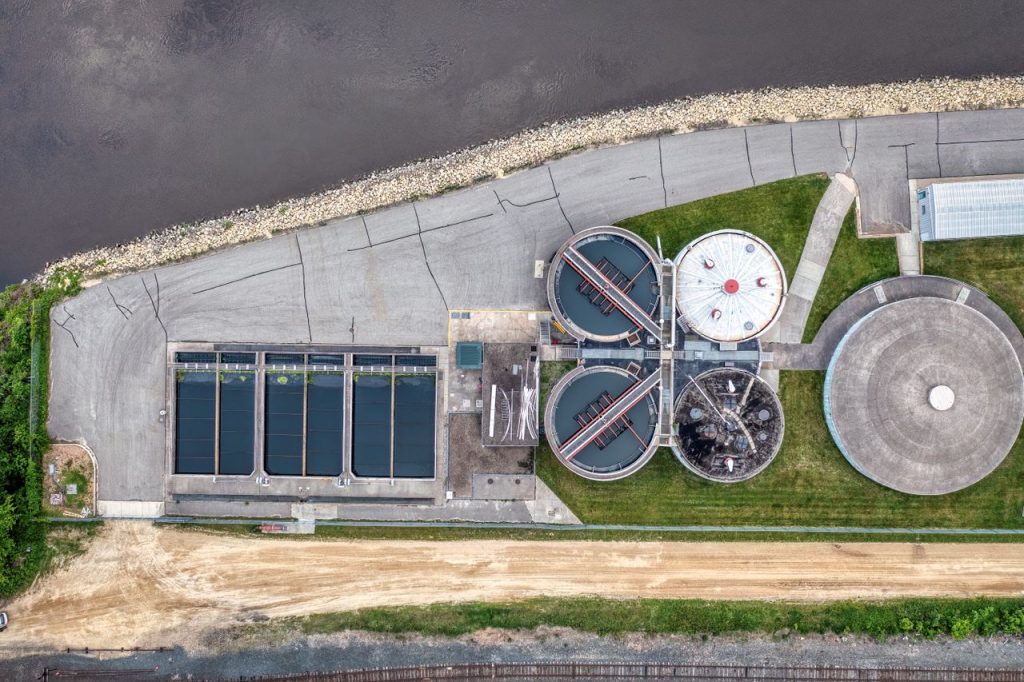 Top-down aerial view of a water treatment plant in Red Wing, MN near a river.
