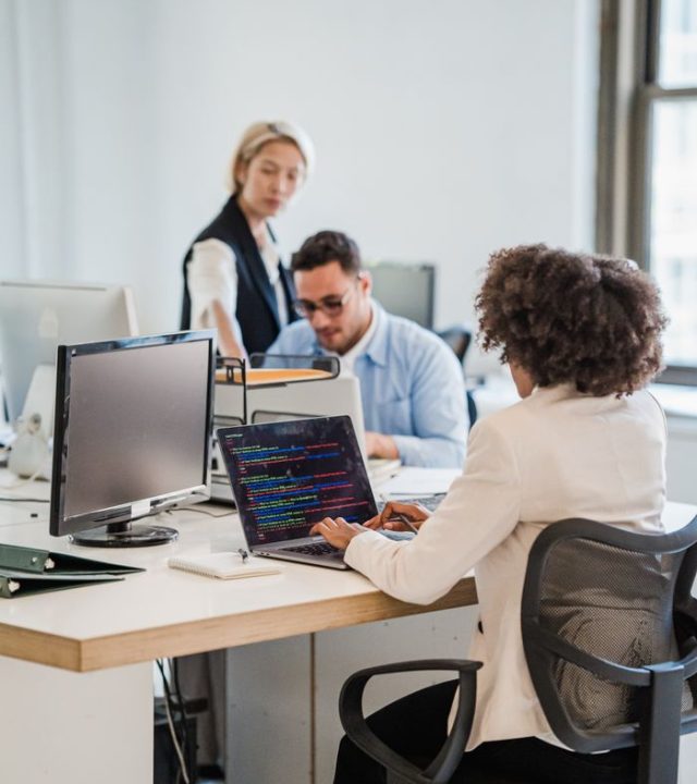 A diverse team engaging in professional work at a shared office space.